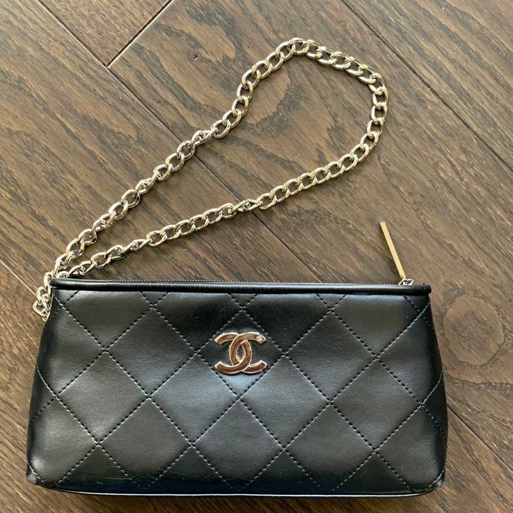 Black quilted wristlet with silver tone chain.